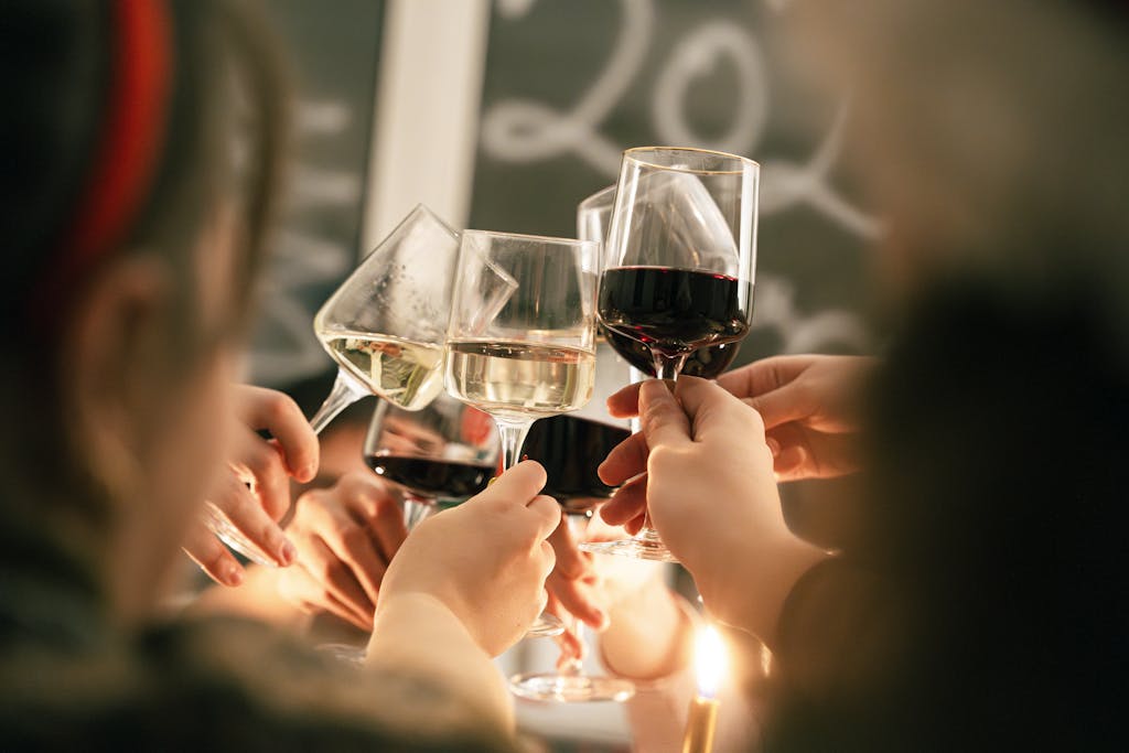 Close-up of a group toasting with wine glasses during a celebration.