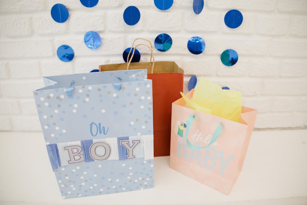 Colorful gift bags and decorations for a boy's baby shower celebration.